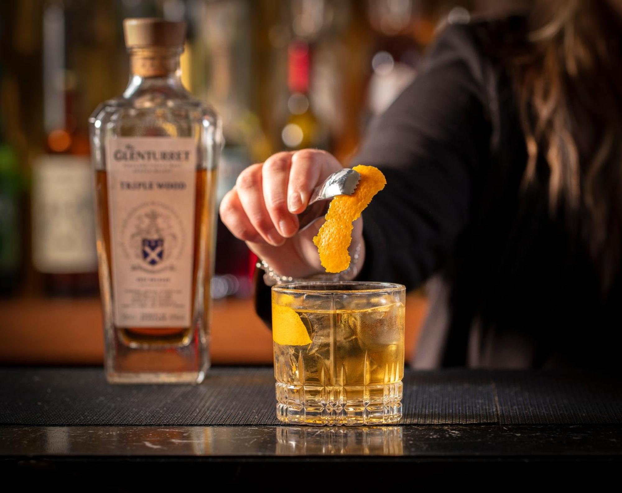 Schloss Roxburghe, Part Of Destination By Hyatt Exterior foto A bartender adding a lemon twist to a glass of GINfinity